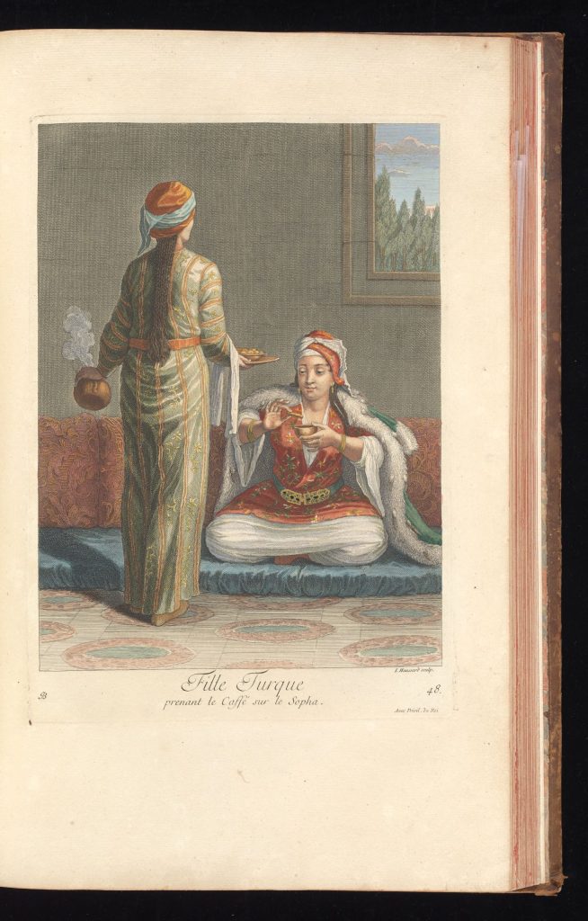 Turkish girl drinking coffee on a sofa